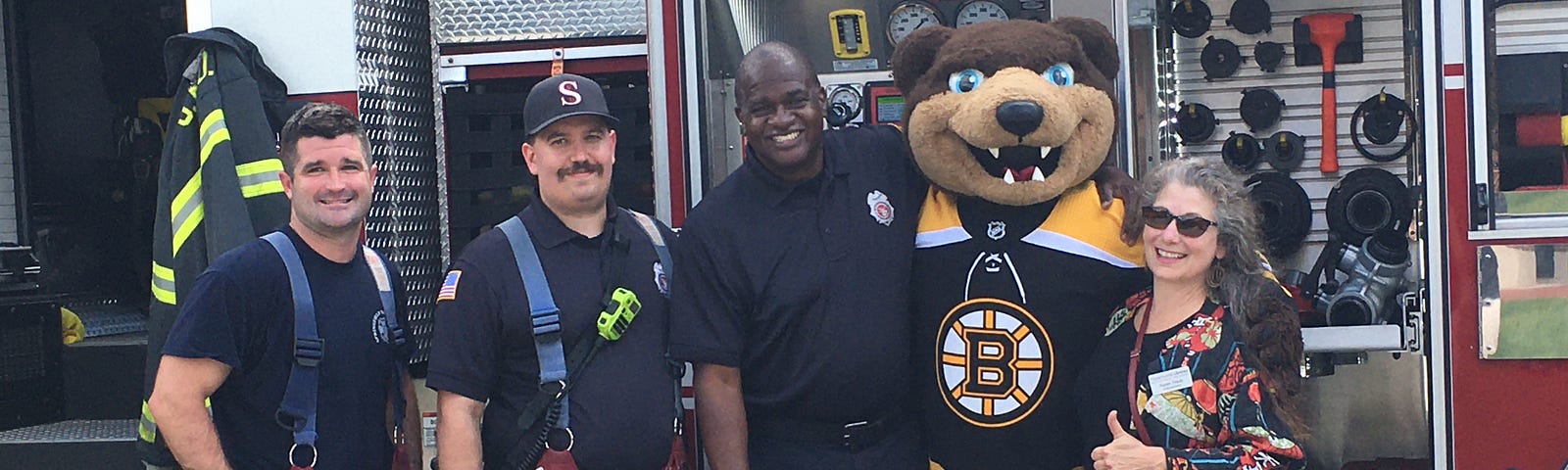 a fire truck with fire fighters, the Boston Bruins Mascot and the author