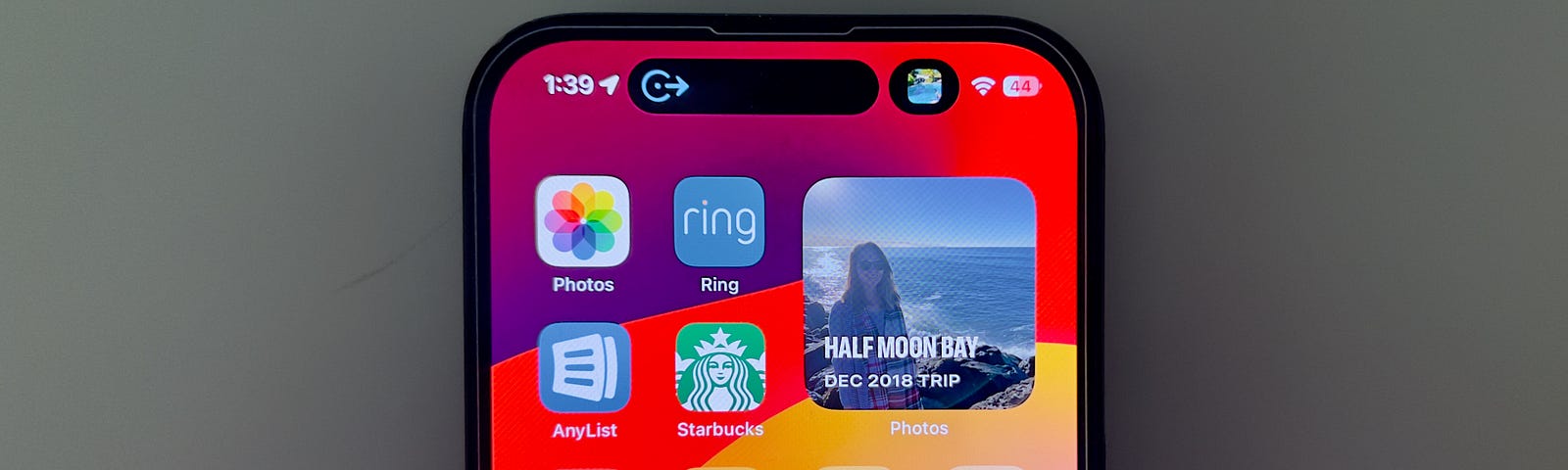 iPhone 14 Pro’s Dynamic Island showing Navigation and Music playing.