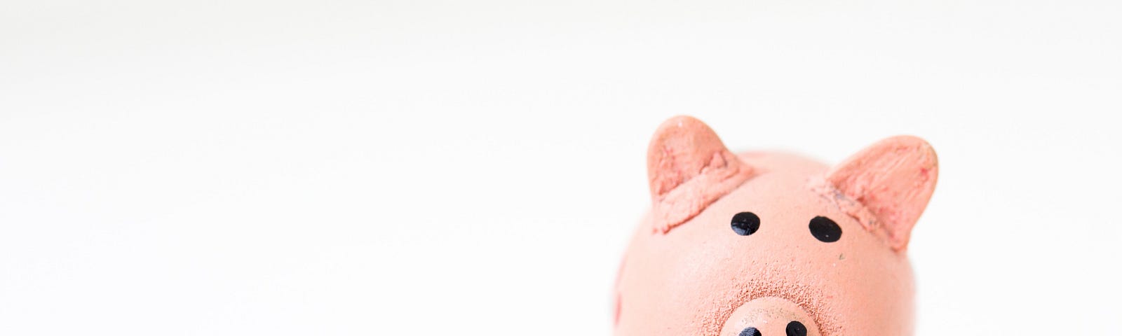 a pink piggy bank pig on an all white background