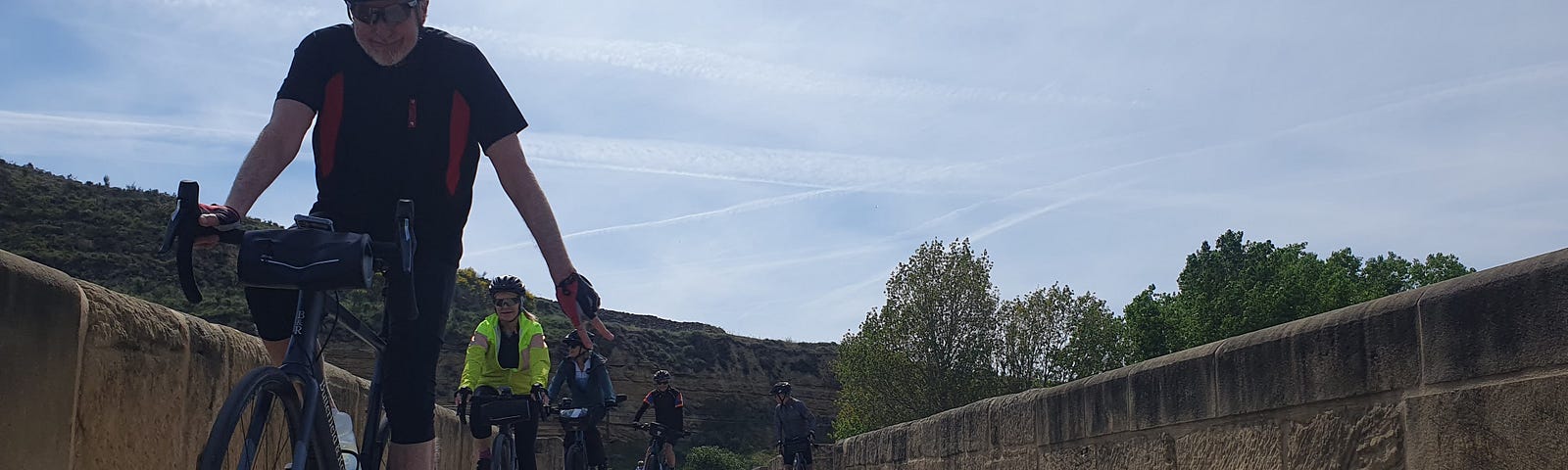 Riders on a bicycle crossing a bridge