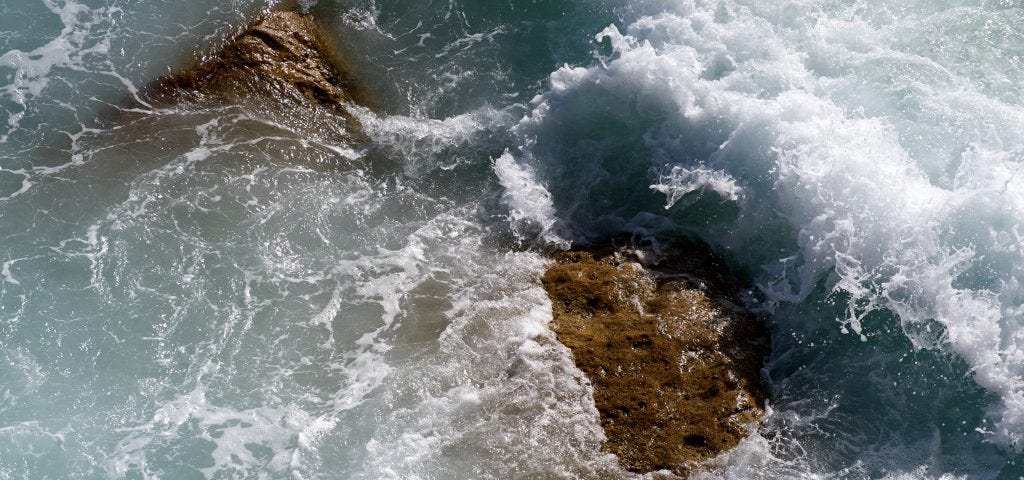 Photograph of waves on rocks, bird’s-eye view, at Bondi beach in Sydney, taken for healing by a medical doctor
