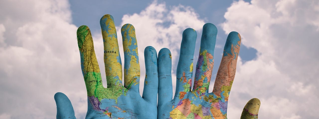 A map of the world painted on a pair of hands