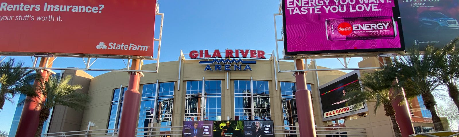 The entrance to Gila River Arena, which has two large billboards in front of it.