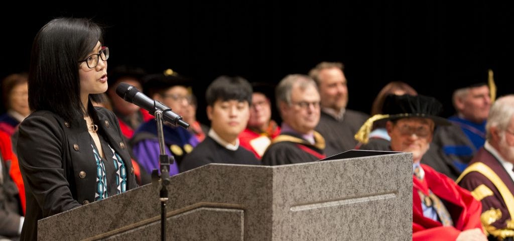 Alyssa Lai at a podium at Convocation for the Humanities Award