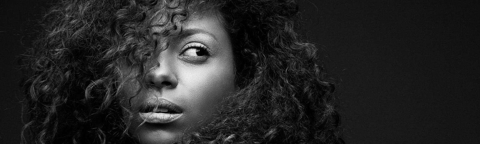 Black and white portrait of a black woman with curly hair