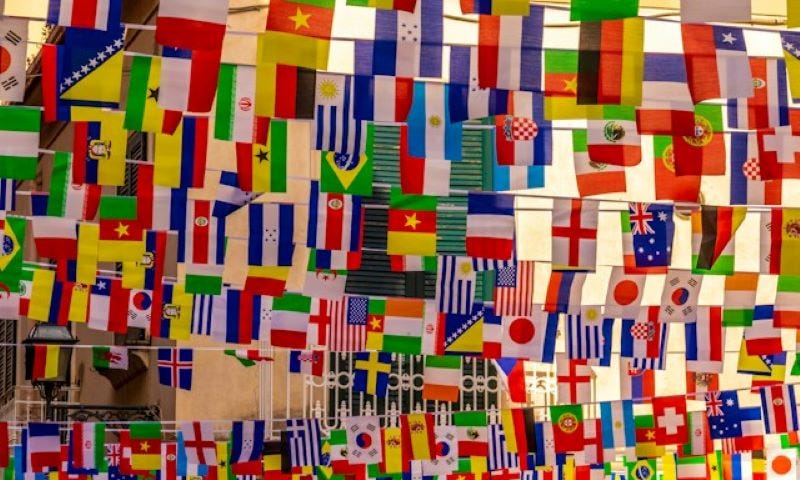 Flags from various countries hanging on lines.