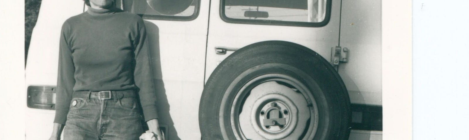 The author, c. 1975, leaning against the back of her white Doge van, named Moby Jane.