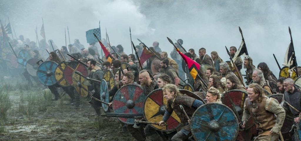 A viking army lined up and charging forward in battle.