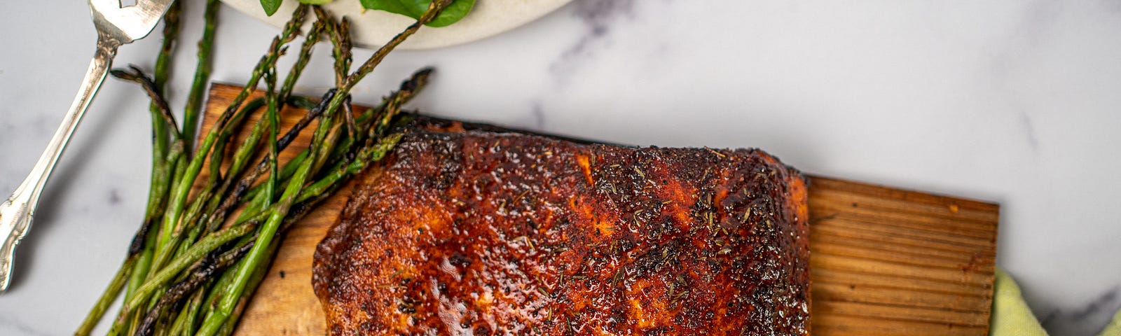 Grilled salmon on a cedar plank with grilled asparagus.