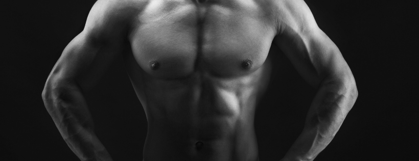 Black and white photo of a man’s naked abs