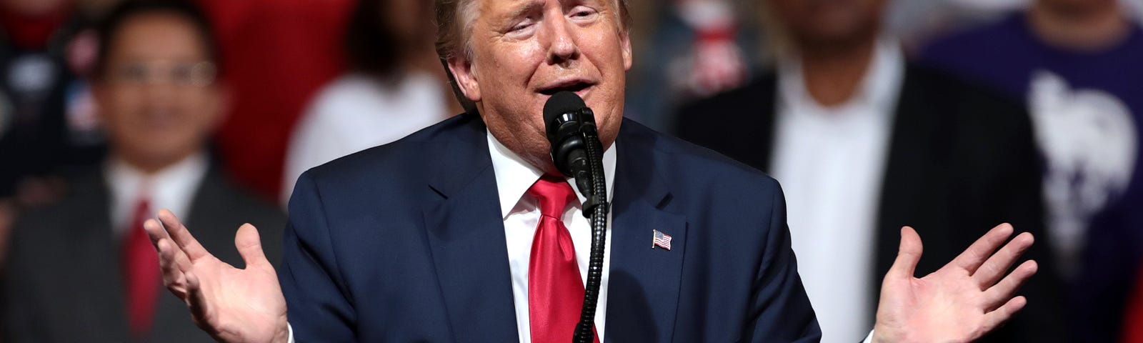 Donald Trump gestures with his hands apart during a speech