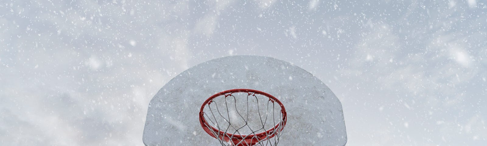 basketball net in frontt of snowy clouds