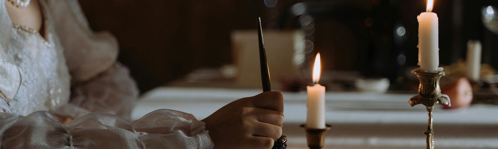 Person dipping Quill Pen in an Ink