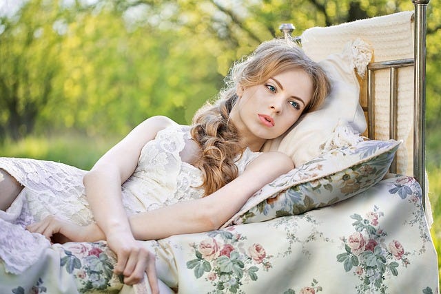 Girl in bed looking wistful