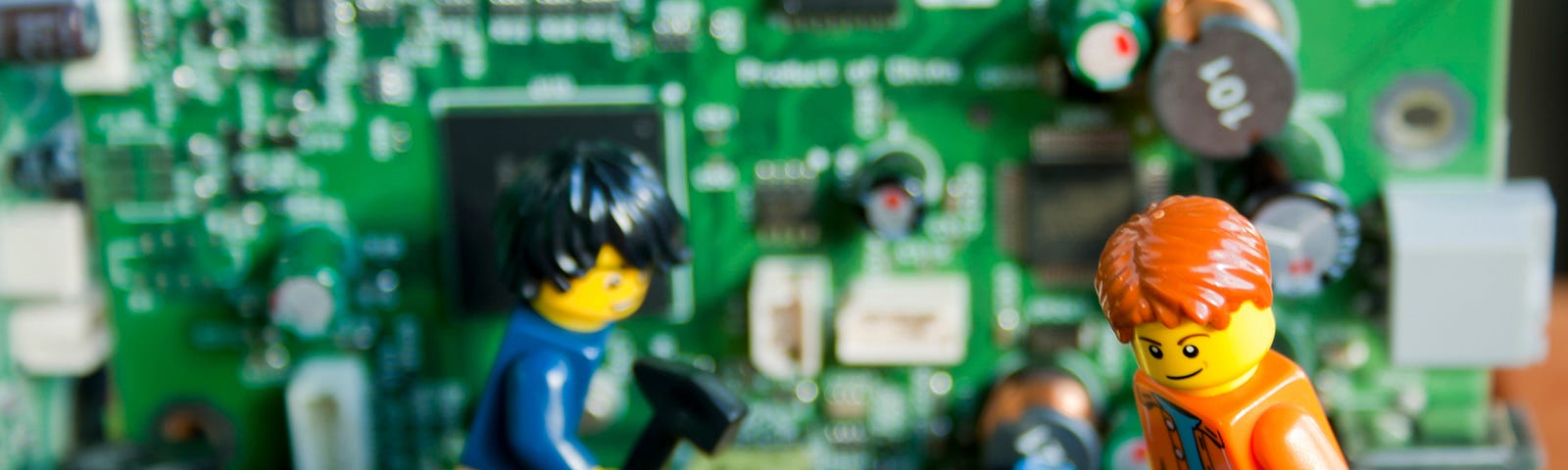 Lego people fixing computers