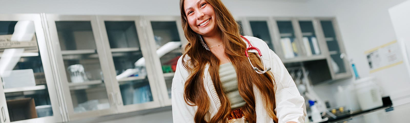 Ranger Gunville, senior in veterinary technology and Pre-Veterinary Medicine, smiles for a photo in a lab