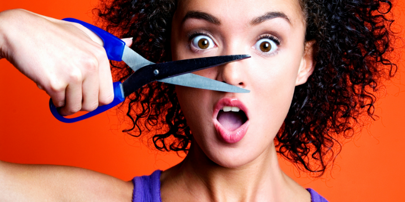 Woman pretending to cut her nose with a pair of scissors — Five English Words That Don’t Make Any Damn Sense