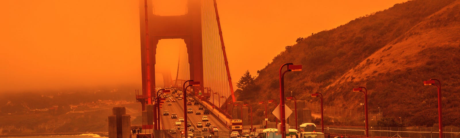 Cars crossing the Golden Gate Bridge in San Francisco under a smoky orange sky caused by California wildfires. Photo by bennymarty/Getty Images