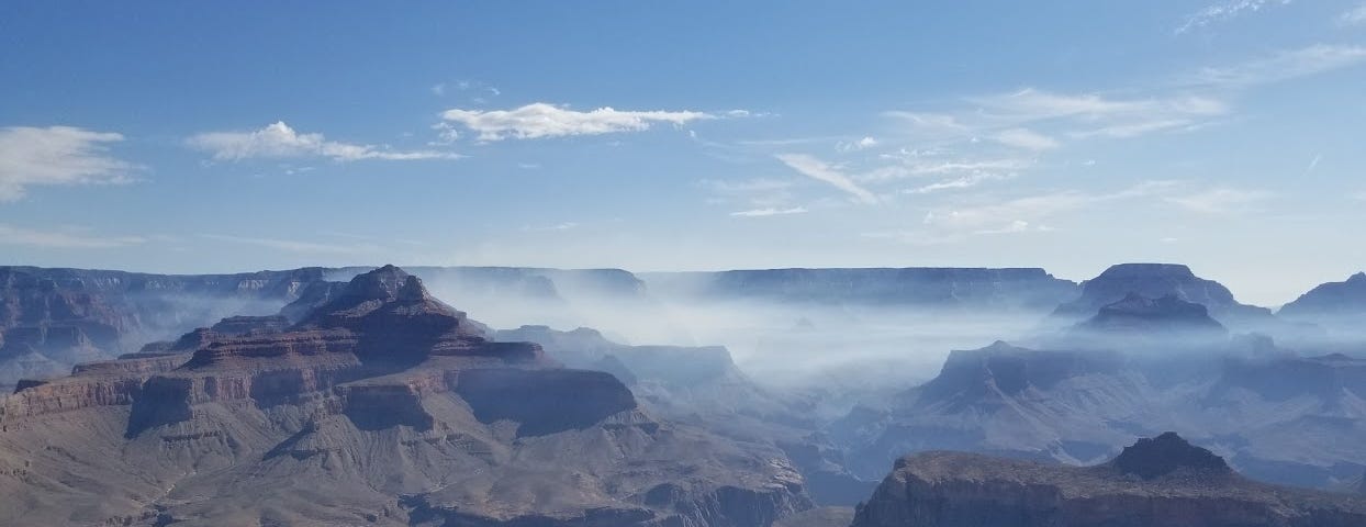 The grand canyon with fog going through the canyon.