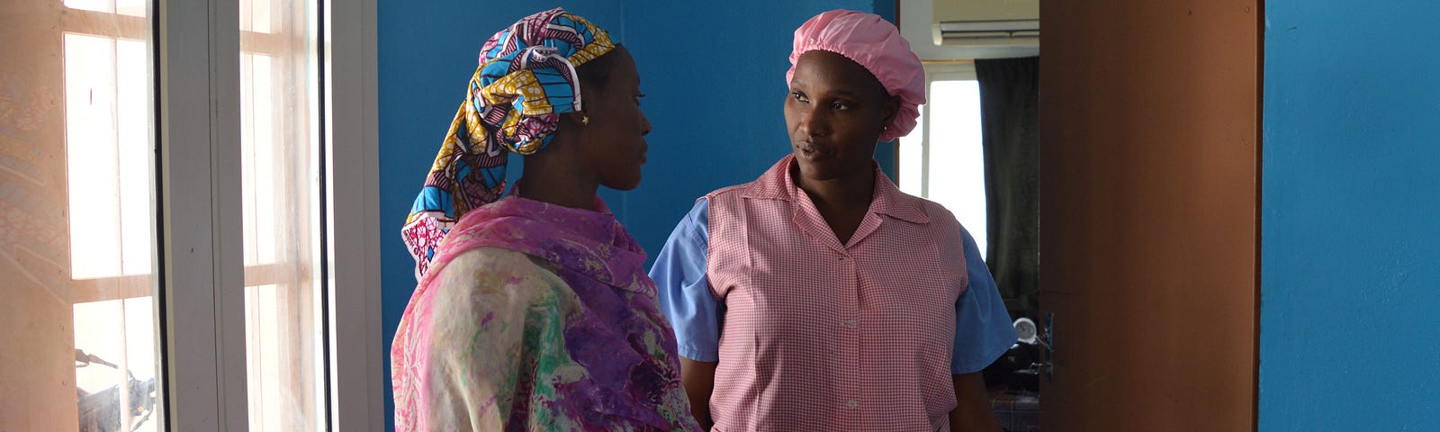 Mama Diancoumba (right) always takes time to reassure her patients and go over their concerns.
