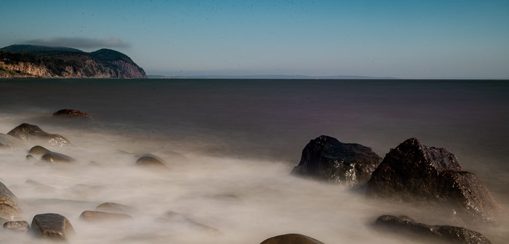 An image of rough water on a rocky beach