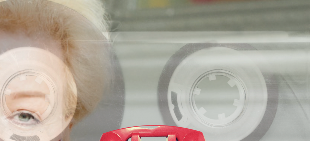 older woman with red phone labeled oval office