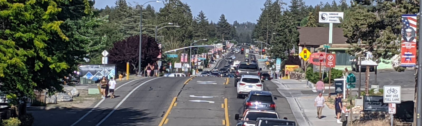 View of cars driving through mountain town.
