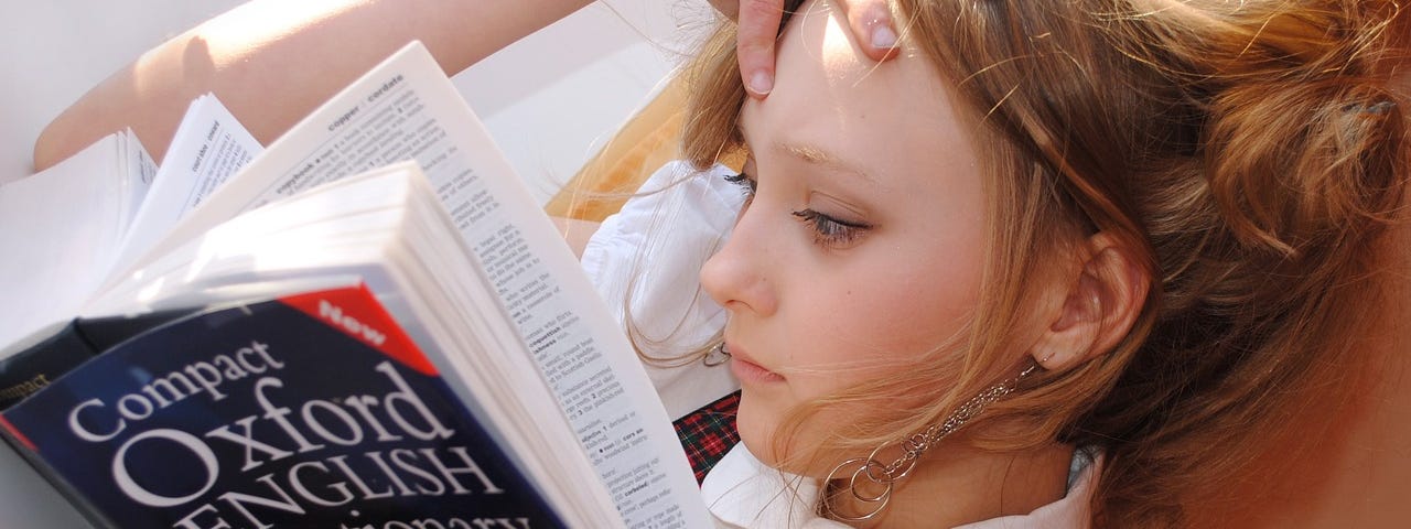 Girl reading a difficult book