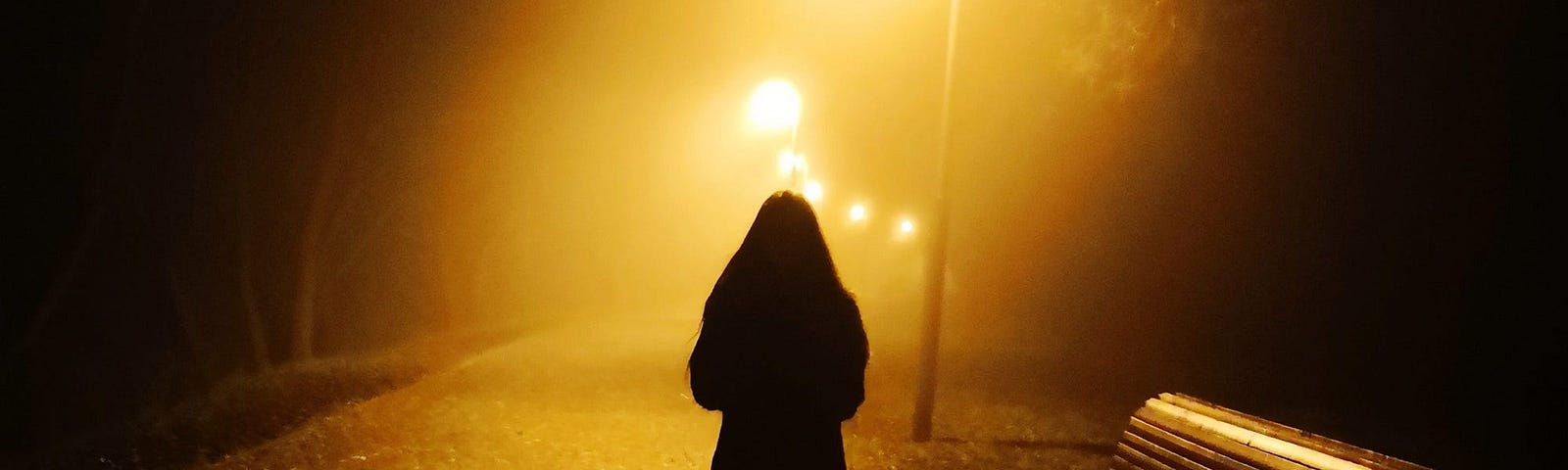 An individual walking at night