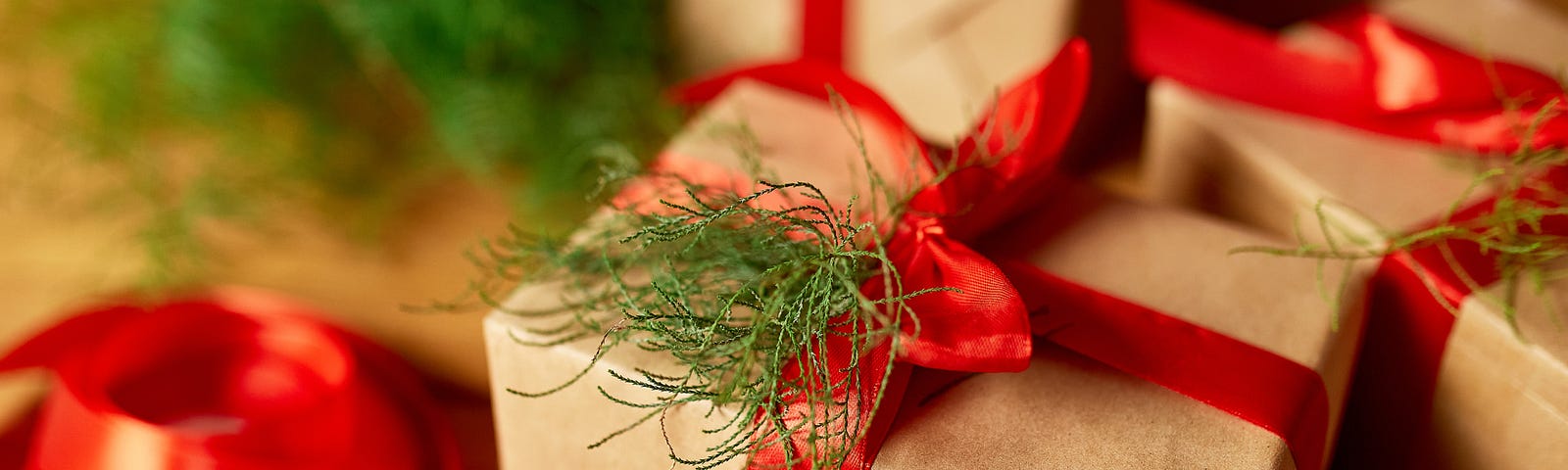 A box wrapped in paper with a red bow.