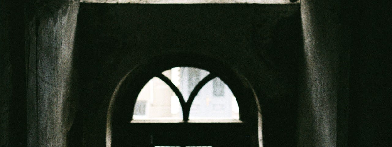 Silhouette of a person standing in a doorway