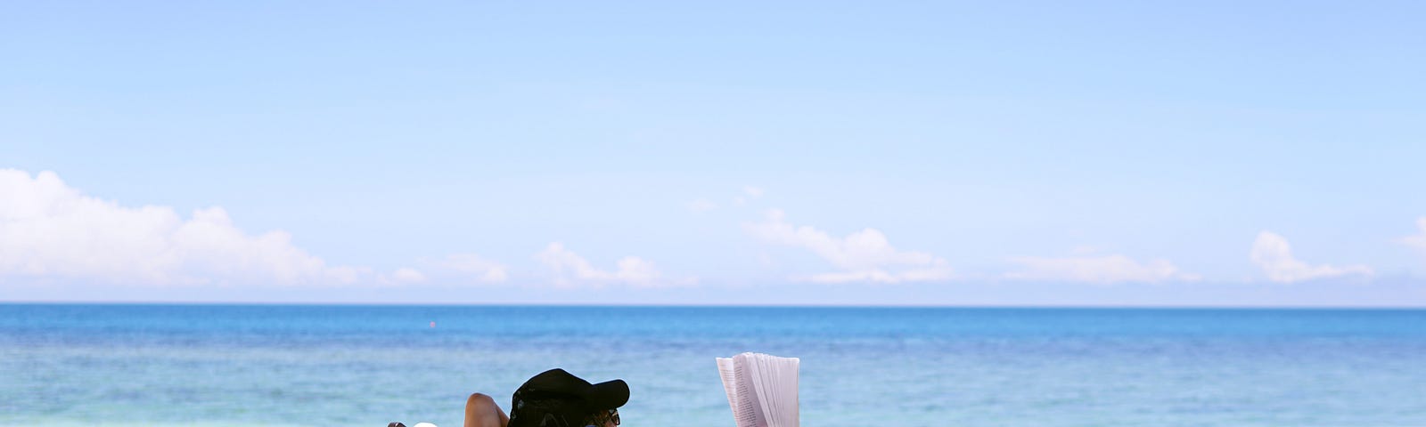 woman sitting in chair on beach