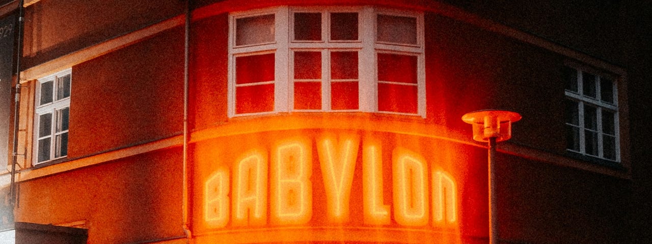 A building with a lighted sign reading “Babylon”