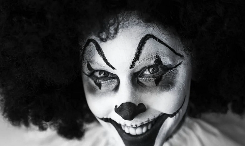 man-in-clown-costume — black and white picture