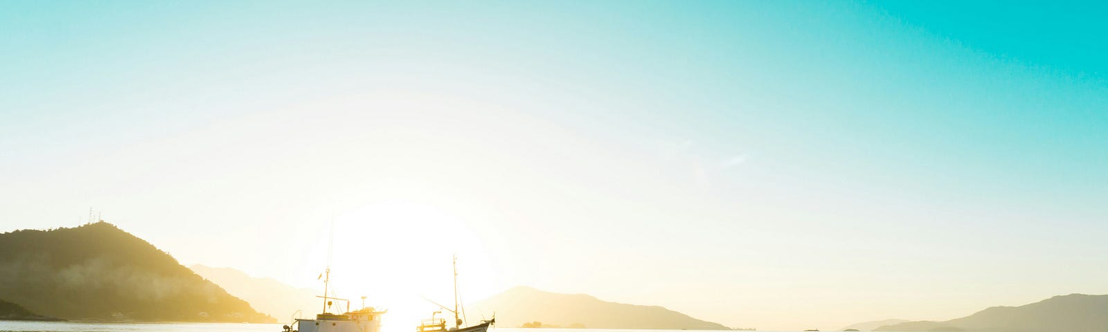 A boat in the water with the rising sun in the background.