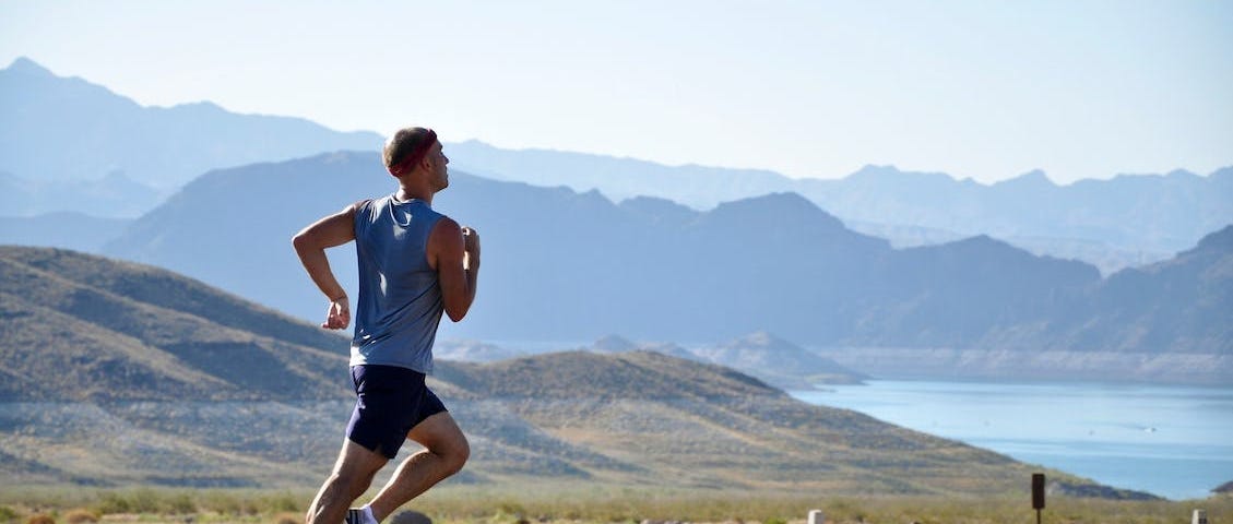 Man runnin on the side of a road