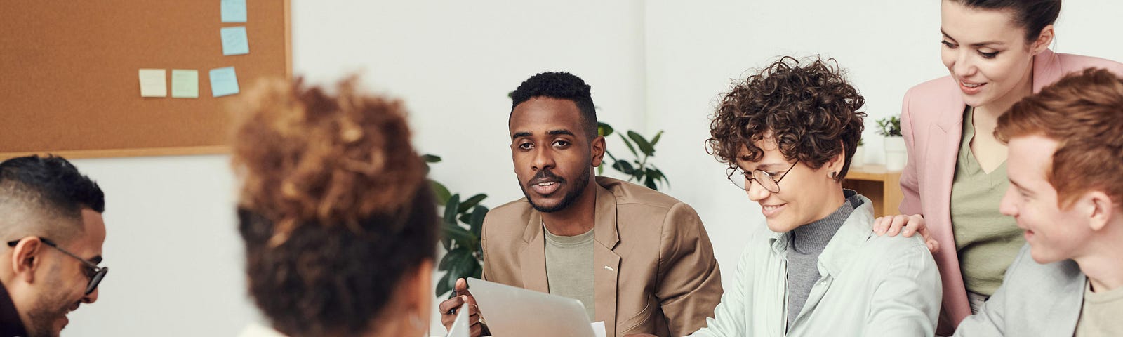 A healthy Scrum Team sitting around a desk collaborating | Photo by fauxels on Pexels