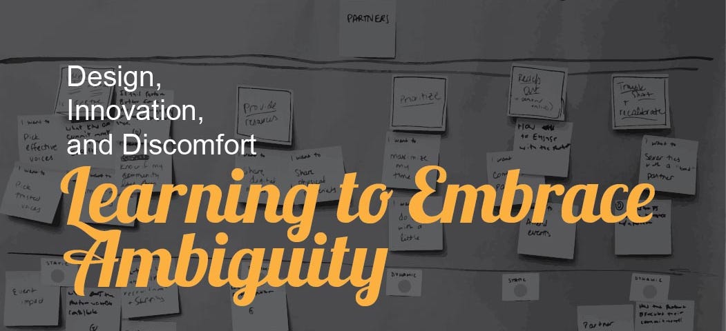 The article title “Learning to Embrace Ambiguity” written in yellow on top of a darkened picture of post-it notes.