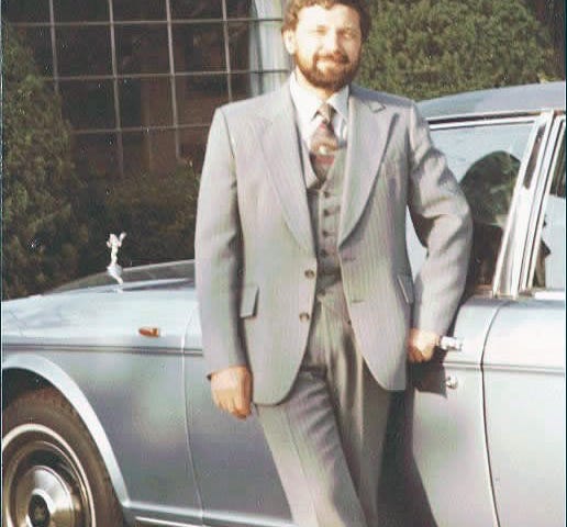 The Author in 1983, three piece suit, nice car, and an inferiority complex.