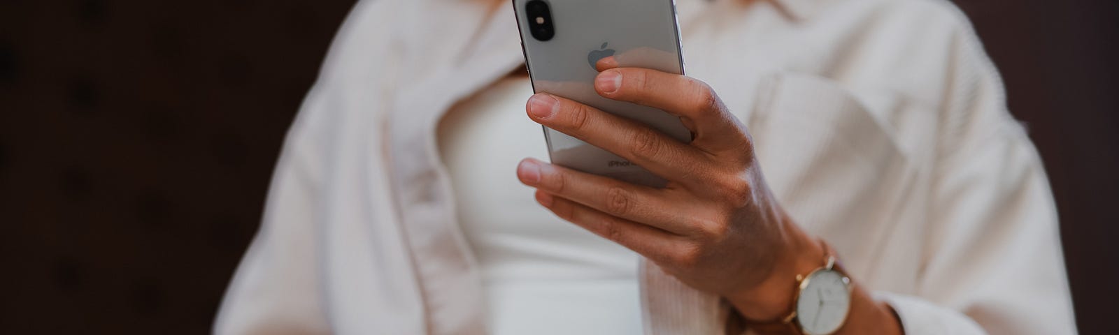 Woman holding a phone in her left hand