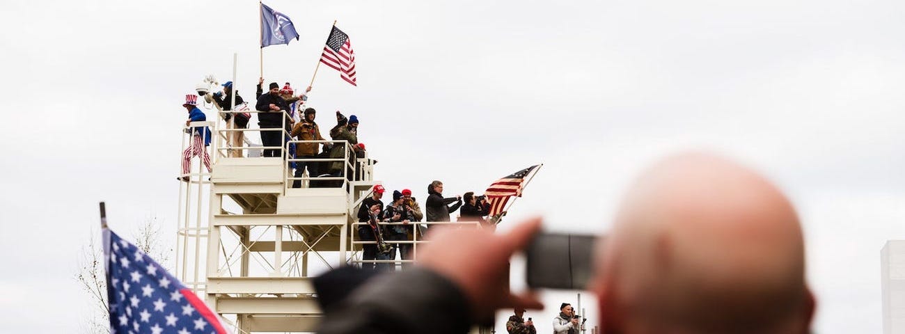 A pro-Trump protester takes a photo of other protesters on the grounds of the Capitol Building on January 6, 2021.