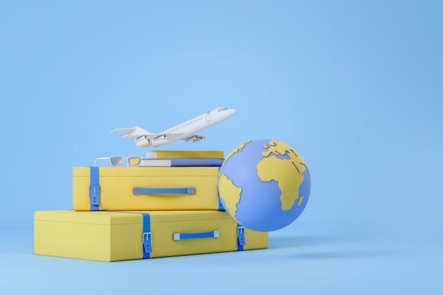 Two suitcases, world globe, and small airplane