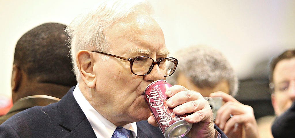 Warren Buffett, CEO of Berkshire Hathaway, drinks a Cherry Coca-Cola as he tours the exhibition floor prior to the Berkshire Hathaway annual meeting in Omaha, Nebraska on May 1, 2010