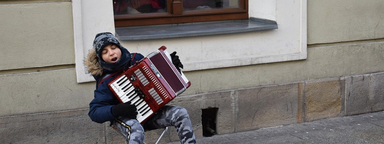 busker playing an accordian
