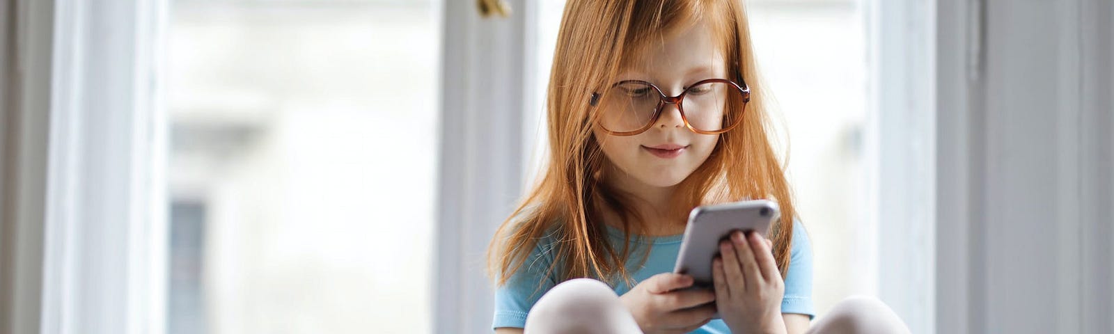 Little girl using a smartphone to check social media