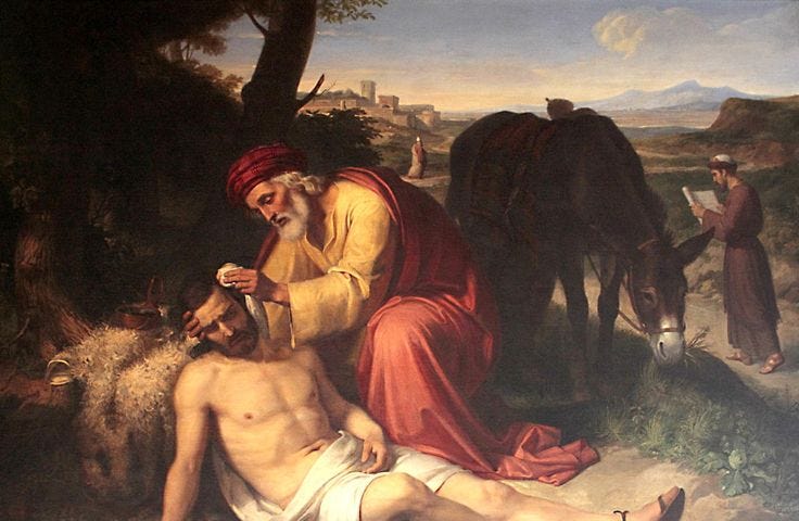 A classical painting. An older man with a white beard, fully clothed, tends to a naked injured man, with a donkey in the background. Further in the background, two other men have walked past the injured man.
