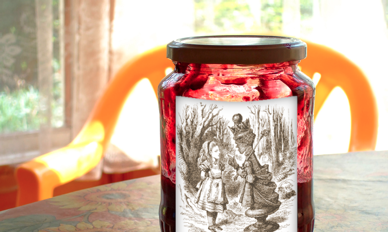 A half-empty jam jar on a table; the jar is labelled with Tenniel’s engraving of the Red Queen wagging her finger at Alice in Through the Looking-Glass.