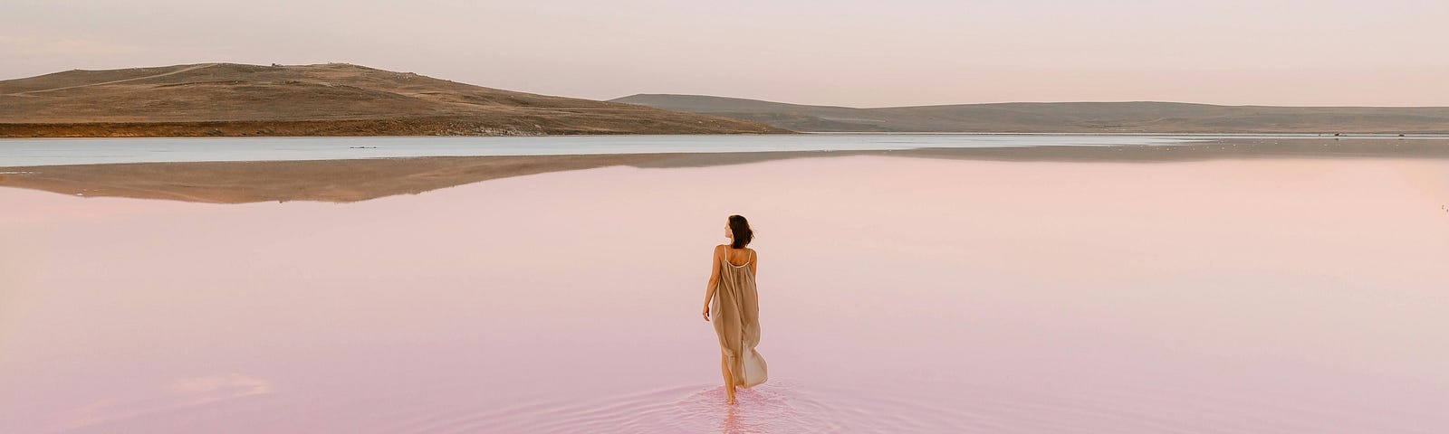 Woman walking in pink water