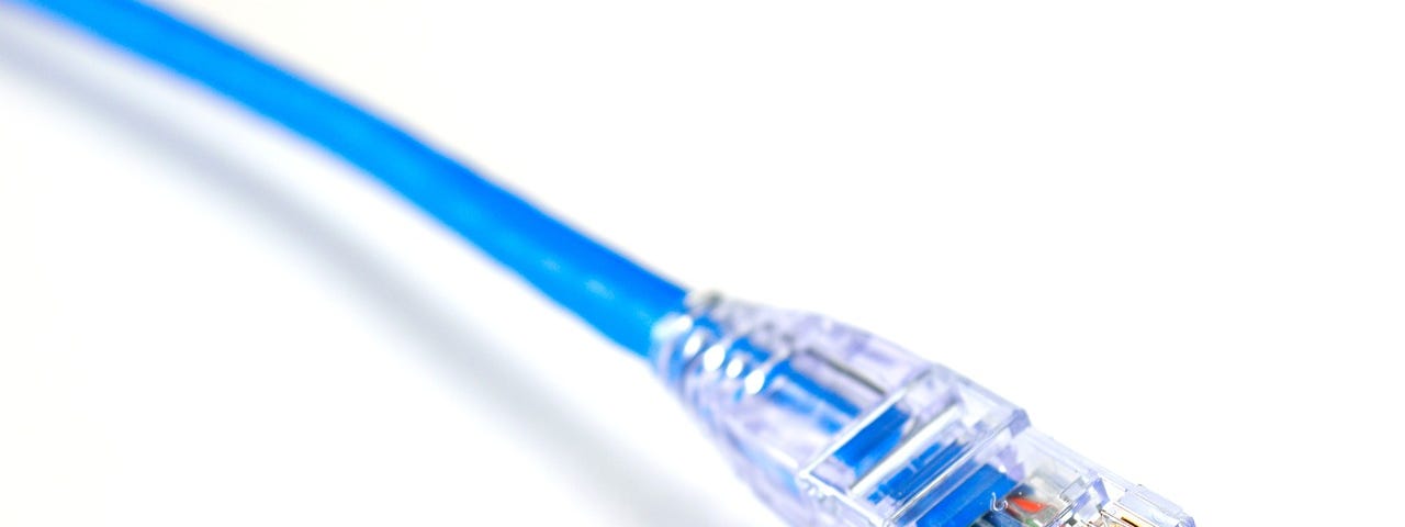 IMAGE: The tip of a blue ethernet cable ending with the RJ45 plug
