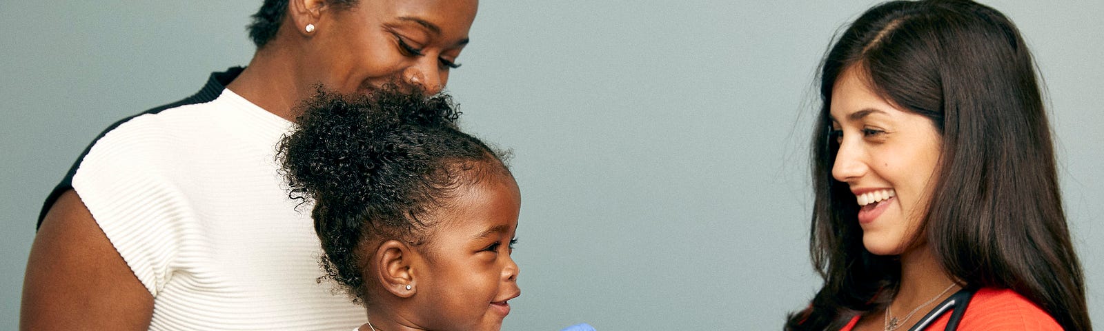 Toddler about to receive a vaccine from a doctor